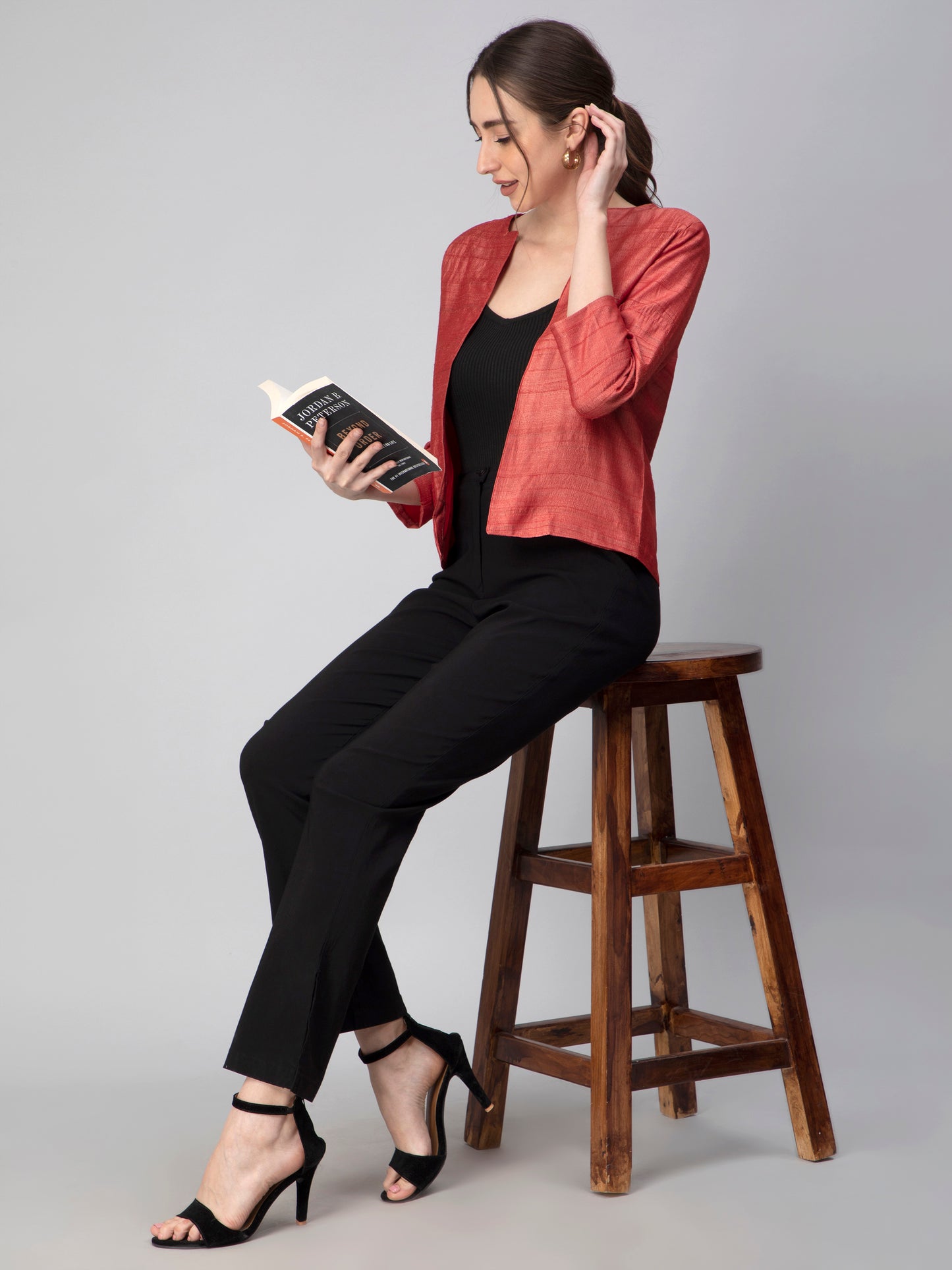 A pretty lady in Earthy RED Pure Tussar Blazer , a office wear for women reading a book