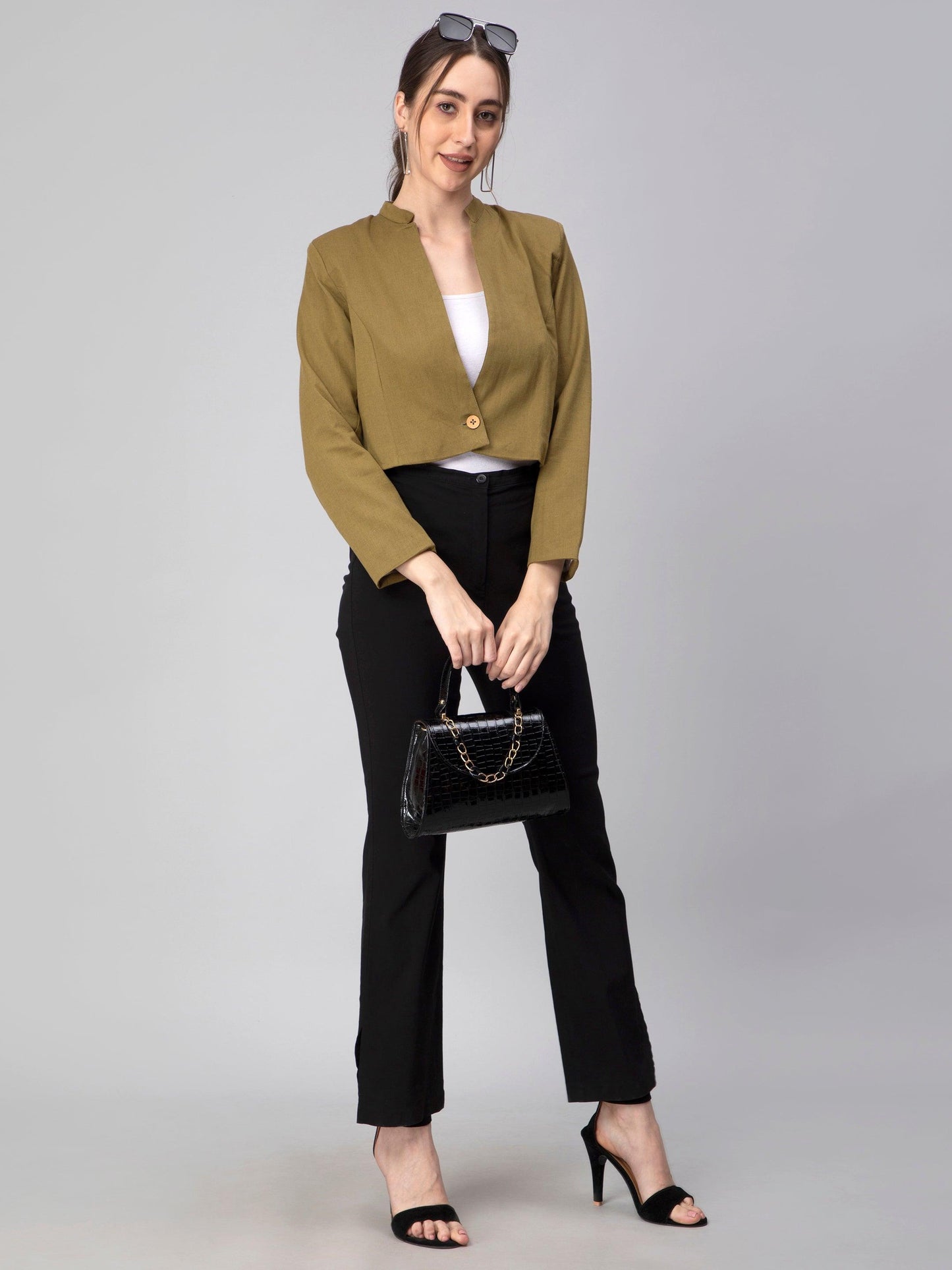 A lady in Green Blazer In Pure Cotton, womens workwear standing against a tan background looking down