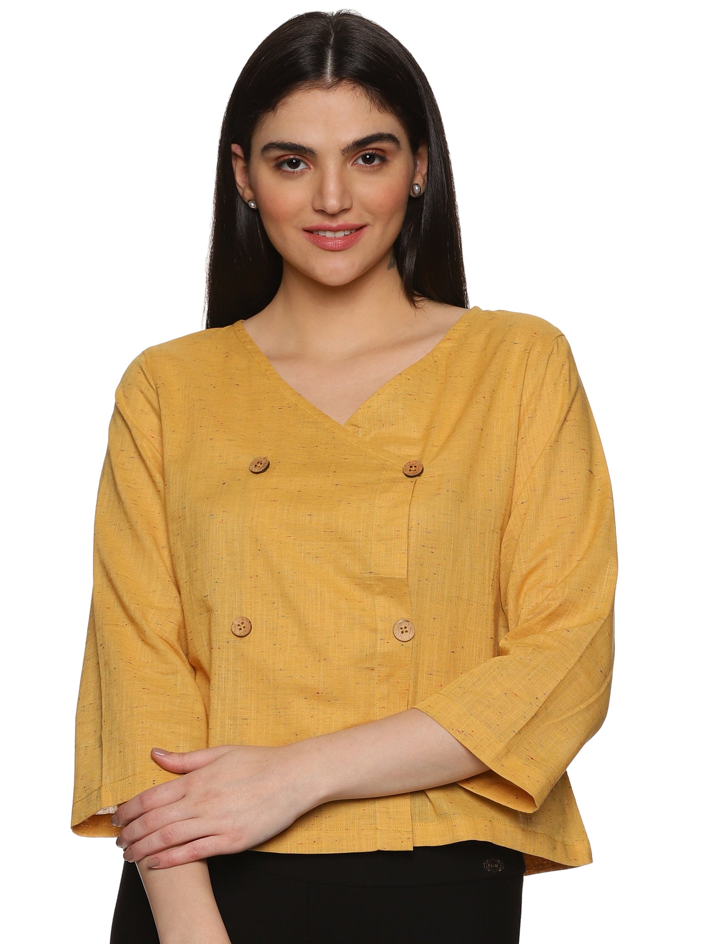 A model in Mustard Asymmetric Neck Side Button Top, a womens workwear is standing against a white background