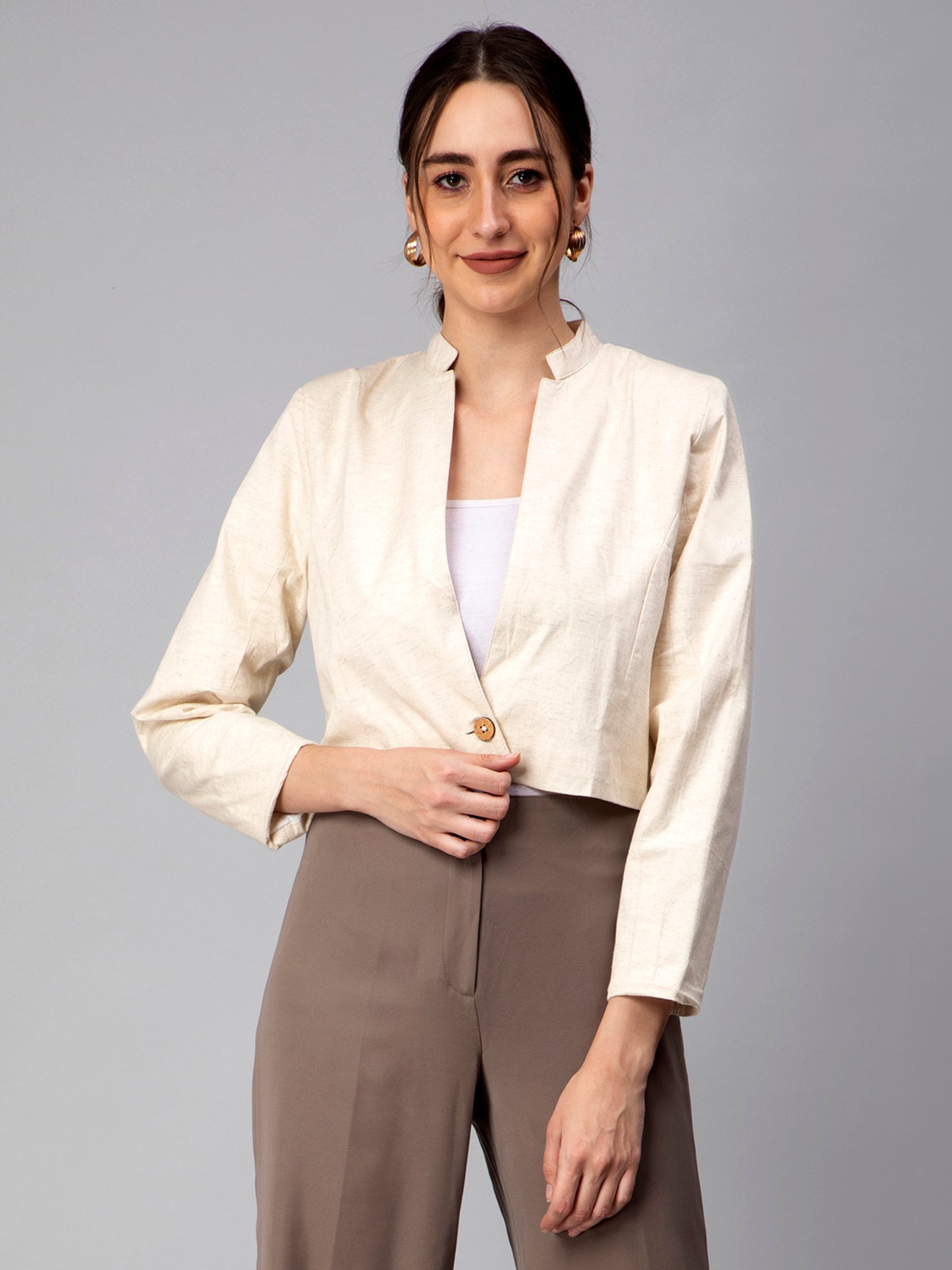 A lady in Beige Blazer In Pure Cotton, womens workwear standing against a tan background 