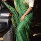 A model in Myrtle Linen Saree in Olive Green a womens workwear is standing near a jeep