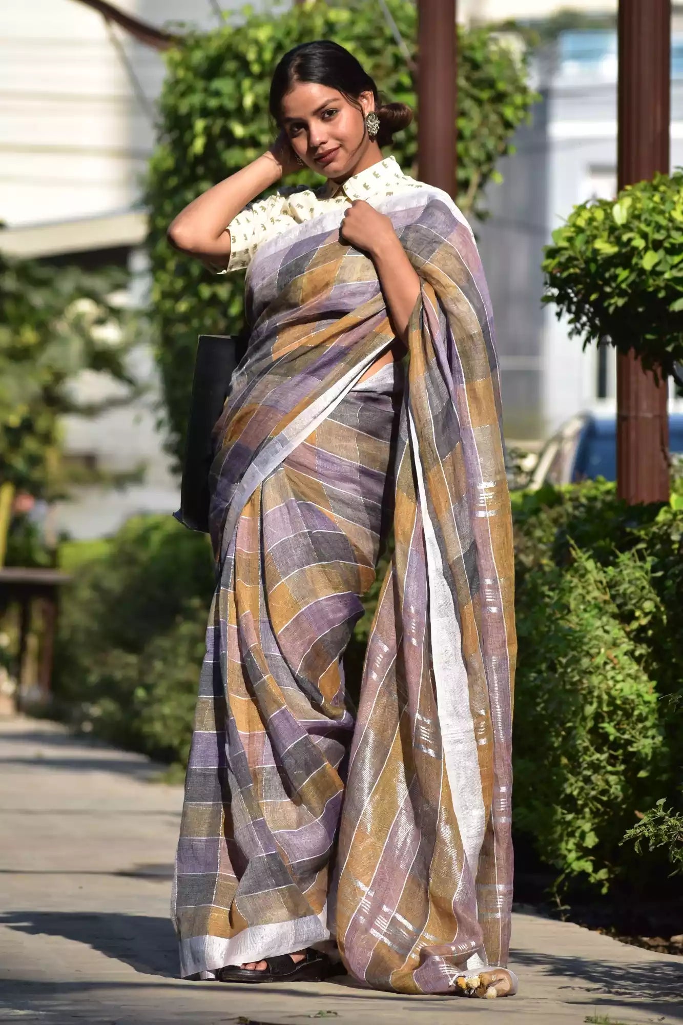 a woman in ethnic posing wearing multicolor checks saree with collared blouse and heels