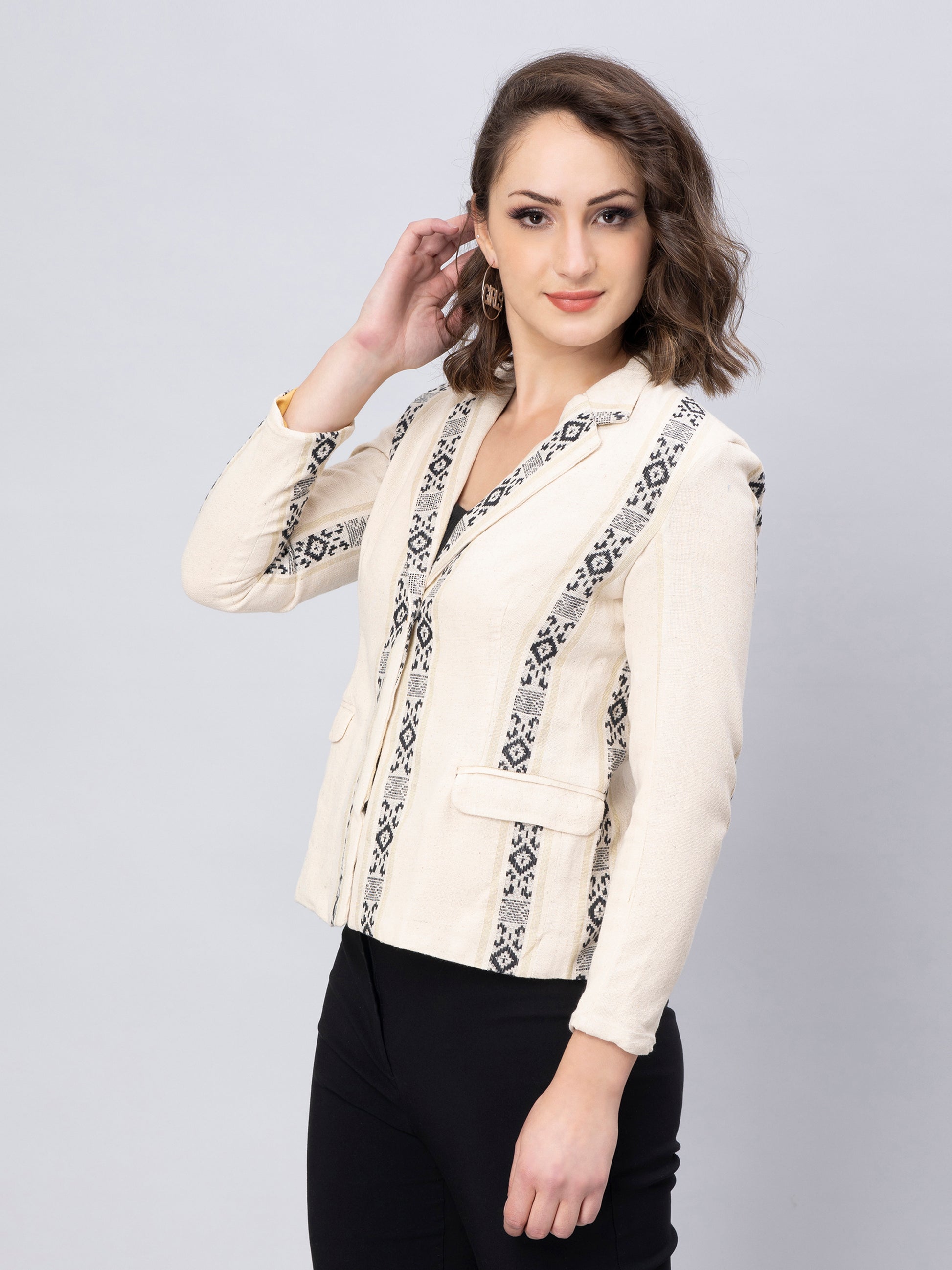 A Women in Elegant Black And White Blazer In Jute Cotton, womens workwear standing against a grey background
