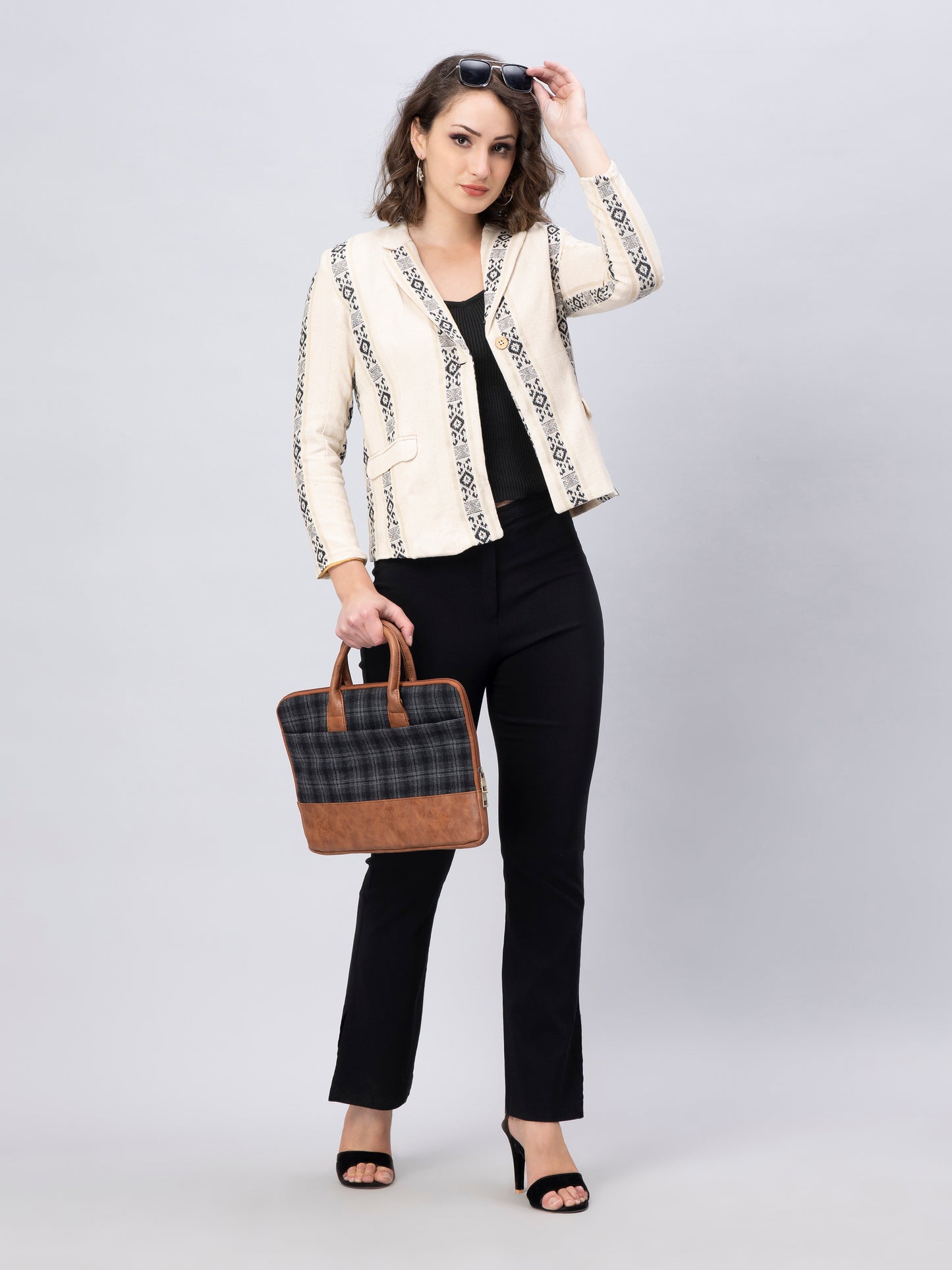 A lady in Elegant Black And White Blazer In Jute Cotton, a office wear for women wearing a handbag