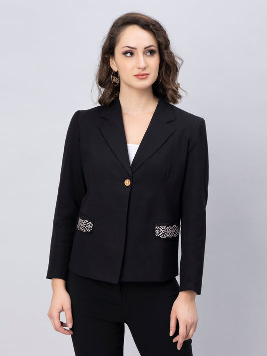 A model in Black solid Blazer with Stylish Motif, a womens workwear is standing against a grey background