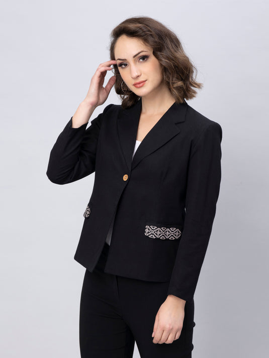 A zoomed out view of lady in Black solid Blazer with Stylish Motif, womens workwear