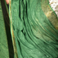 A zoomed in view of women wearing a Myrtle Linen Saree in Olive Green, formal dress for women