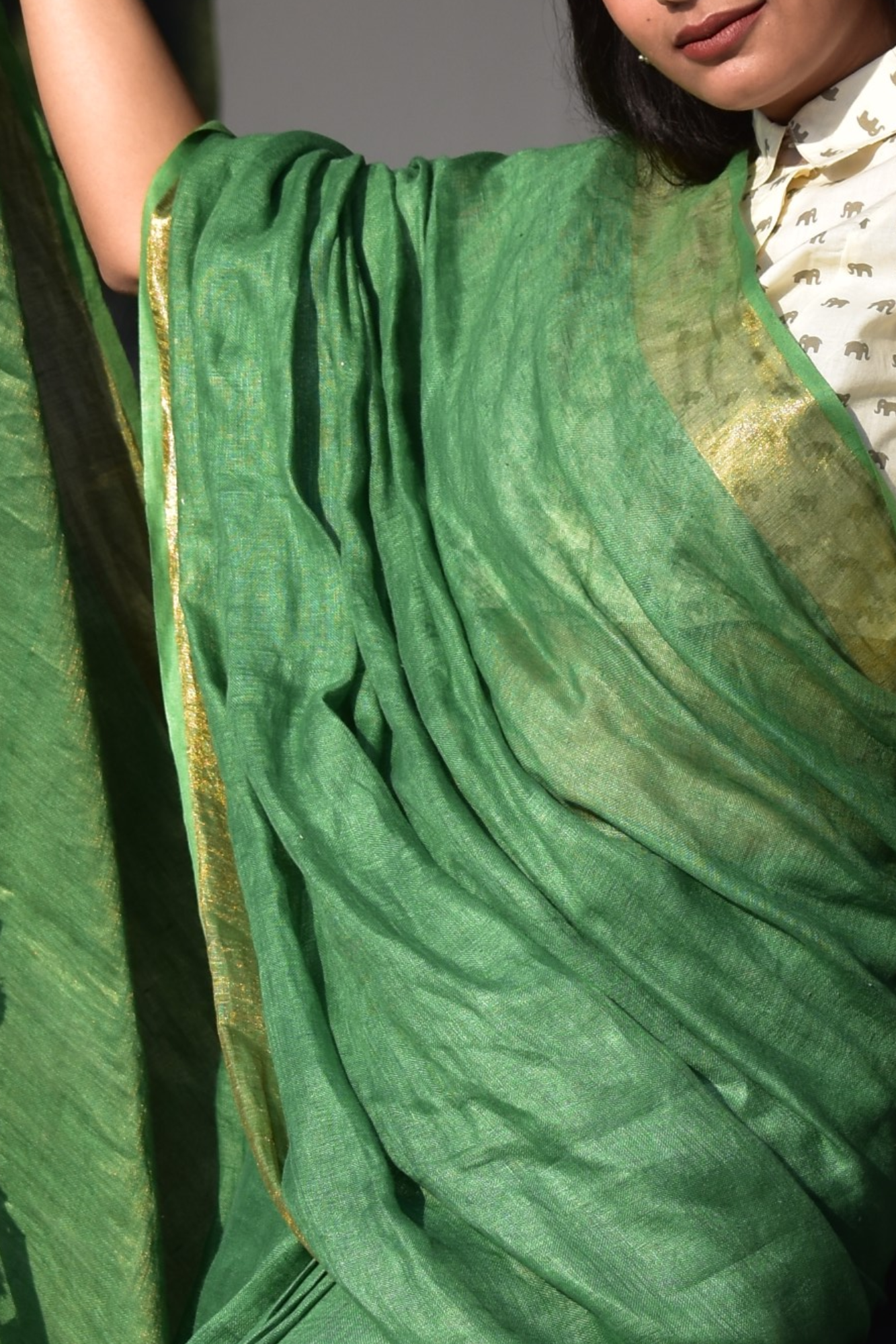 A zoomed in view of women wearing a Myrtle Linen Saree in Olive Green, formal dress for women