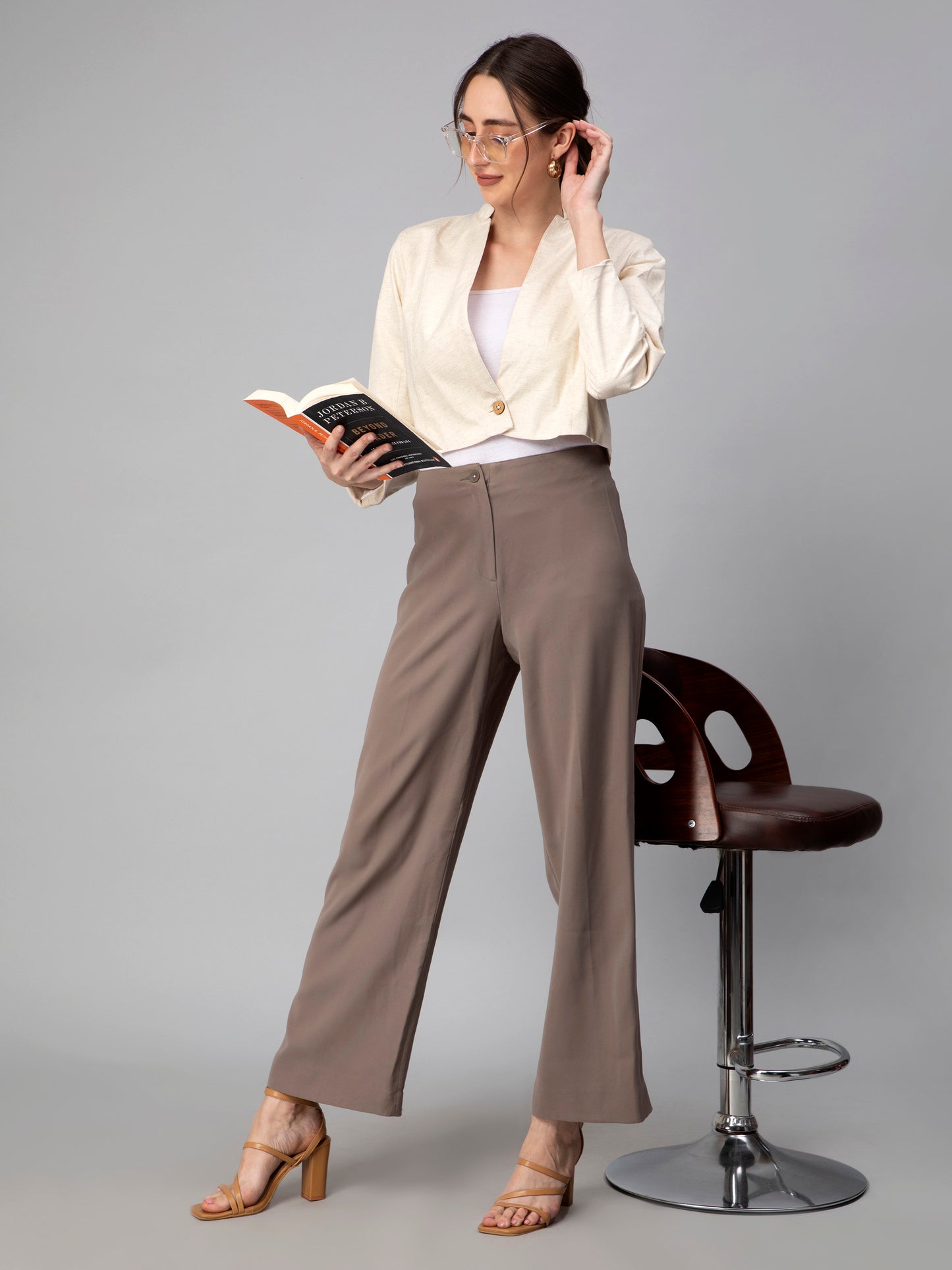 A pretty lady in Beige Blazer In Pure Cotton, a office wear for women reading a book