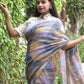 beautiful standing posture of a woman with open hair posing wearing multicolor checks saree with collared blouse