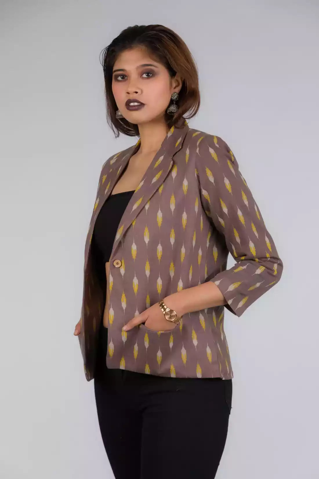 A Women in Grey Yellow Ikkat Blazer In Pure Cotton, womens workwear standing against a grey background