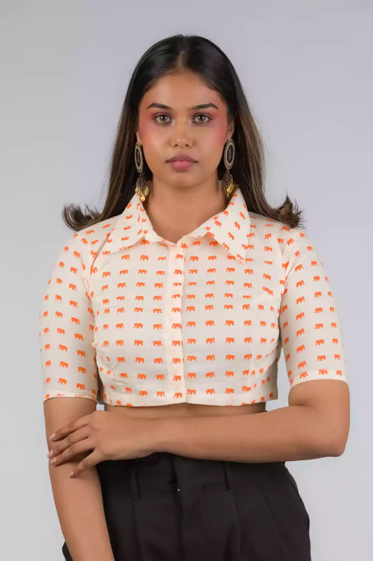 A Women in Elephant Print Mul Cotton Blouse, womens workwear standing against a grey background