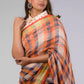 A lady in Linen By Linen Rustic Saree in Beige Checks, womens workwear standing against a beige background looking sideways
