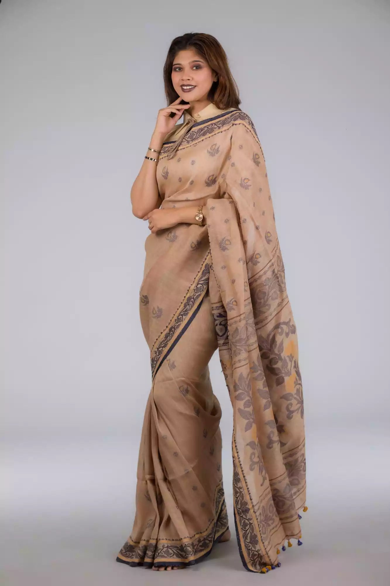 A zoomed out view of lady in Handwoven Soft Linen Cotton Saree in Beige and Black, womens workwear