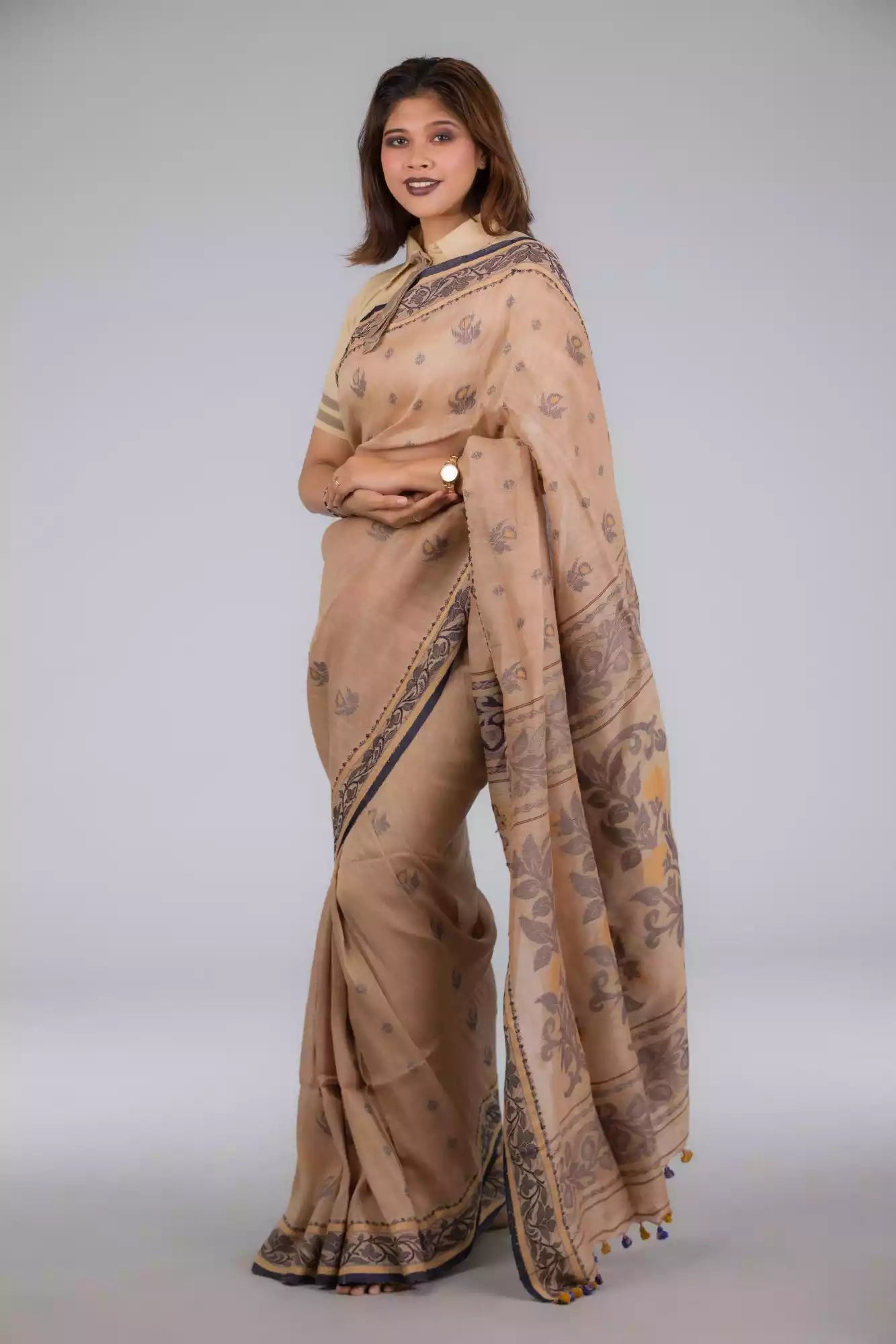 A model in Handwoven Soft Linen Cotton Saree in Beige and Black a womens workwear is standing against a grey background