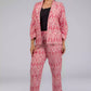 A Women in Pink Woven Ikkat bottom In Pure Cotton, womens workwear standing against a grey background