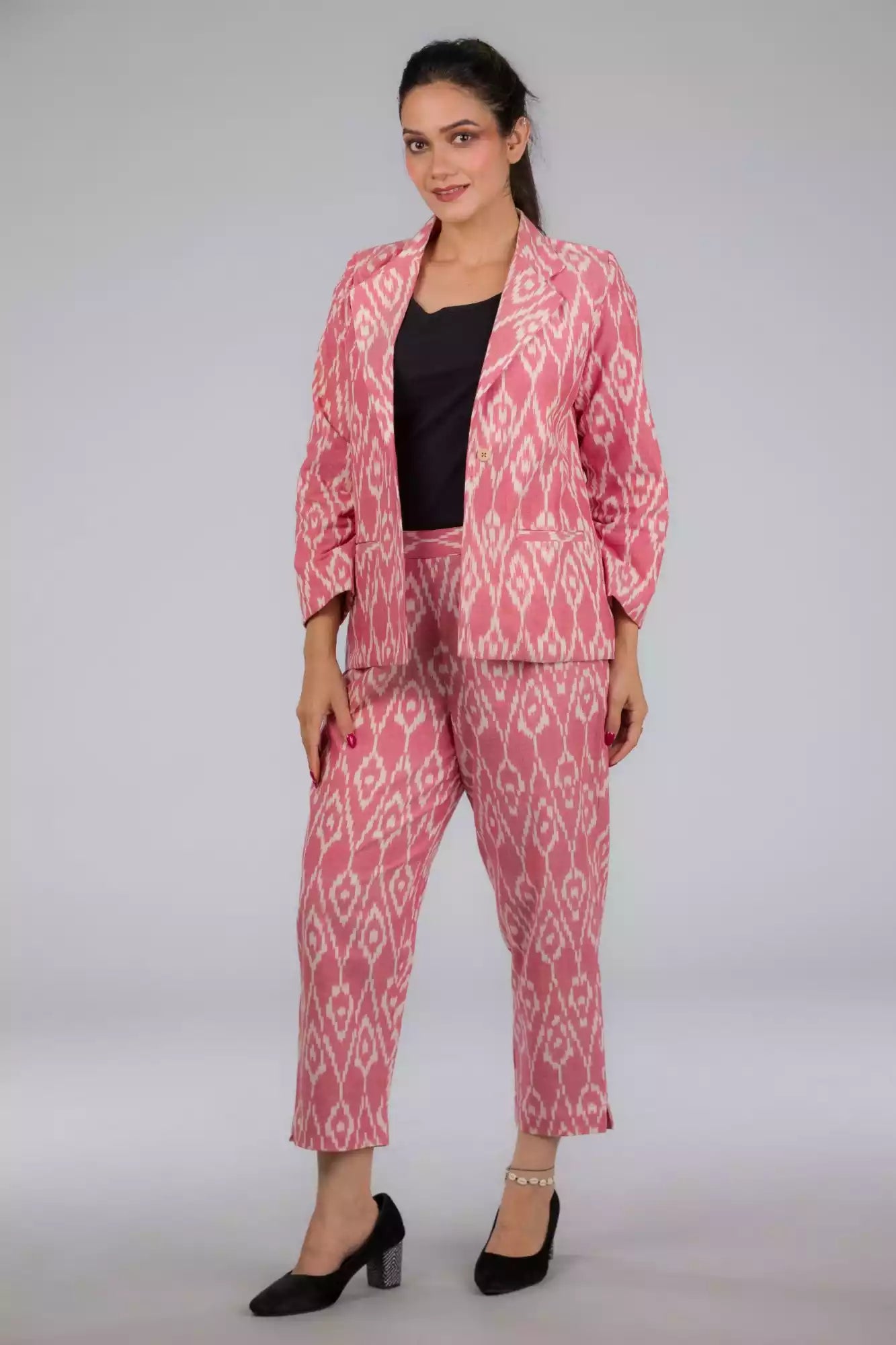A Women in Pink Woven Ikkat bottom In Pure Cotton, womens workwear standing against a grey background