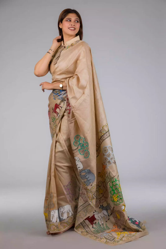 An aesthetic image of lady in Pure Tussar in Beige Saree adorned with Patachitra, womens workwear  looking sideways