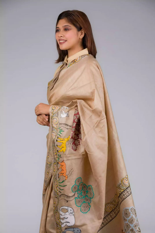 A side profile of lady in Pure Tussar in Beige Saree adorned with Patachitra, womens workwear  