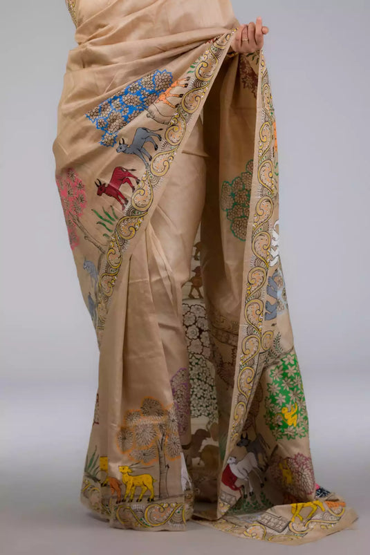 A zoomed in view of women wearing a Pure Tussar in Beige Saree adorned with Patachitra, formal dress for women showing the patterns in the saree