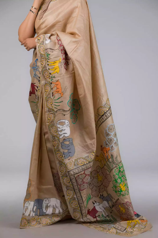 A zoomed in view of women wearing a Pure Tussar in Beige Saree adorned with Patachitra, formal dress for women