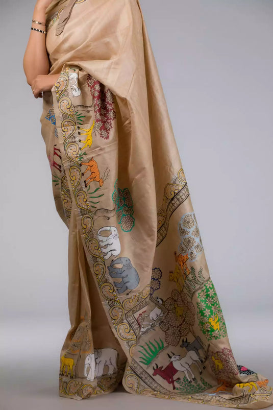 A zoomed in view of women wearing a Pure Tussar in Beige Saree adorned with Patachitra, formal dress for women showing the side profile