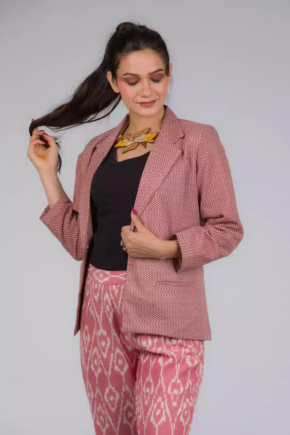 A lady in Chevron Red Blazer In Pure Cotton, womens workwear standing against a grey background
