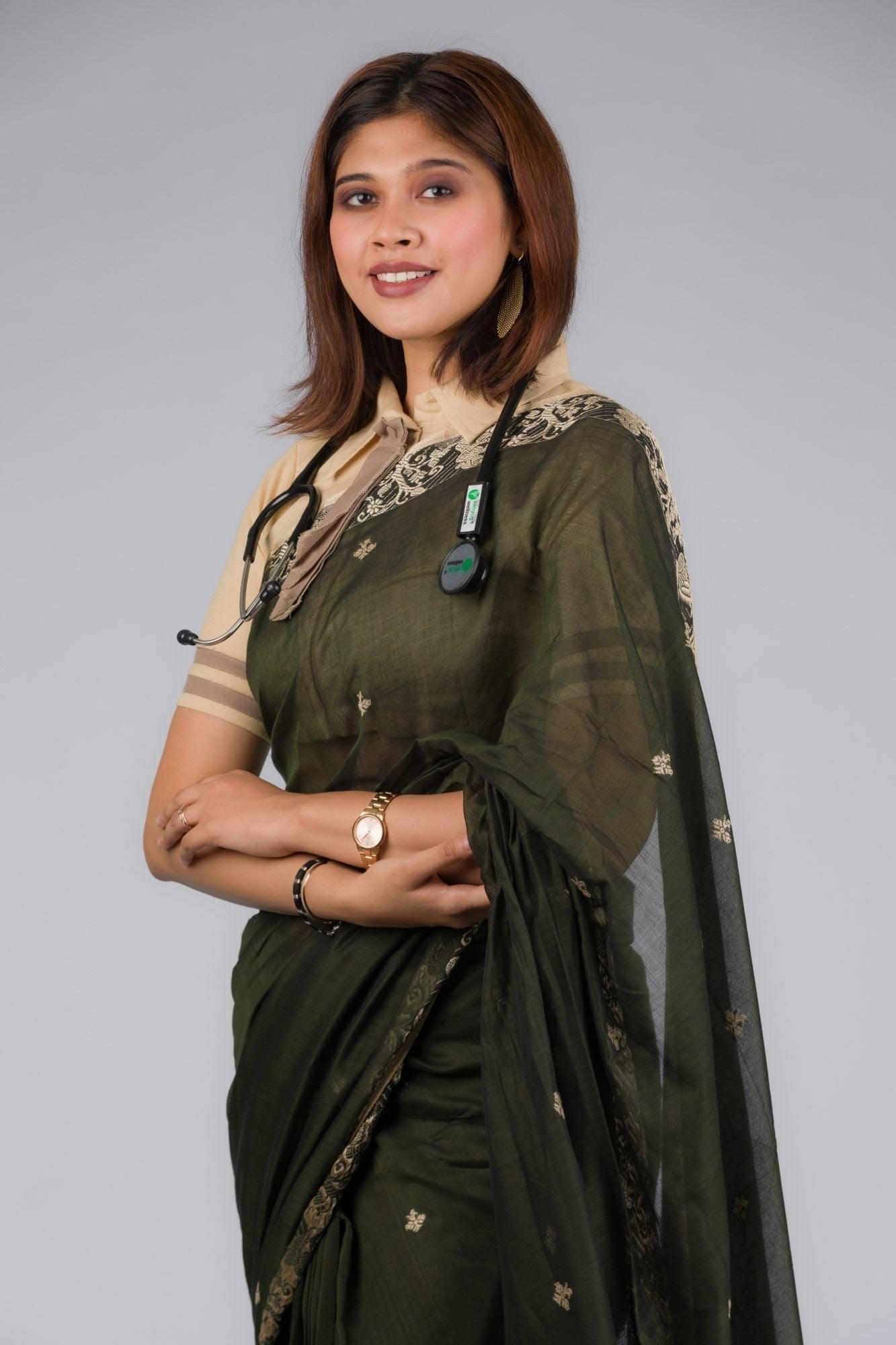 A model in Baluchari Pure Cotton Saree in Algae Green a womens workwear is standing against a grey background