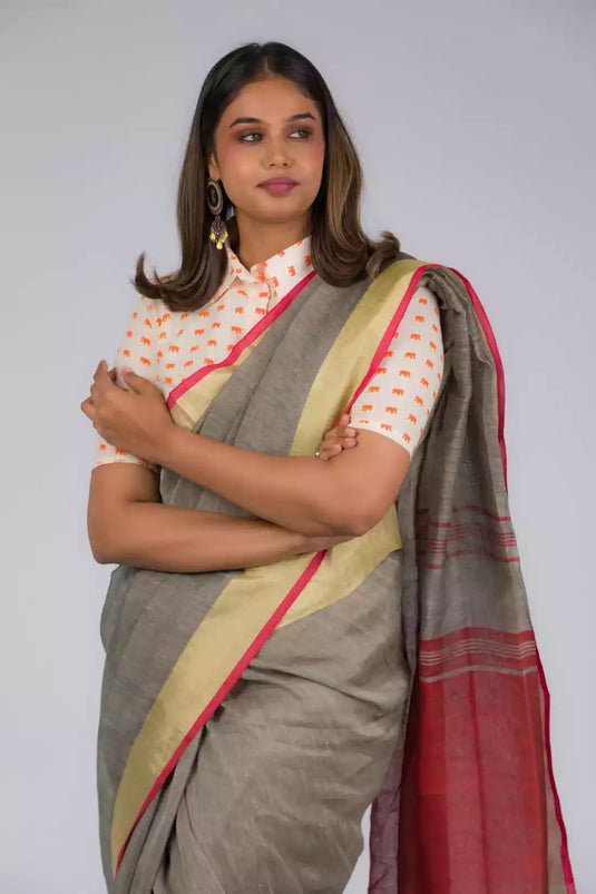 An aesthetic image of lady in Shades of Grey Linen Cotton with Orange Border Saree, womens workwear 