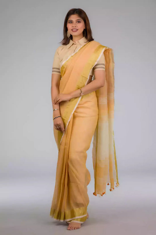 a beautiful woman with short hair wearing beige saree with collared blouse