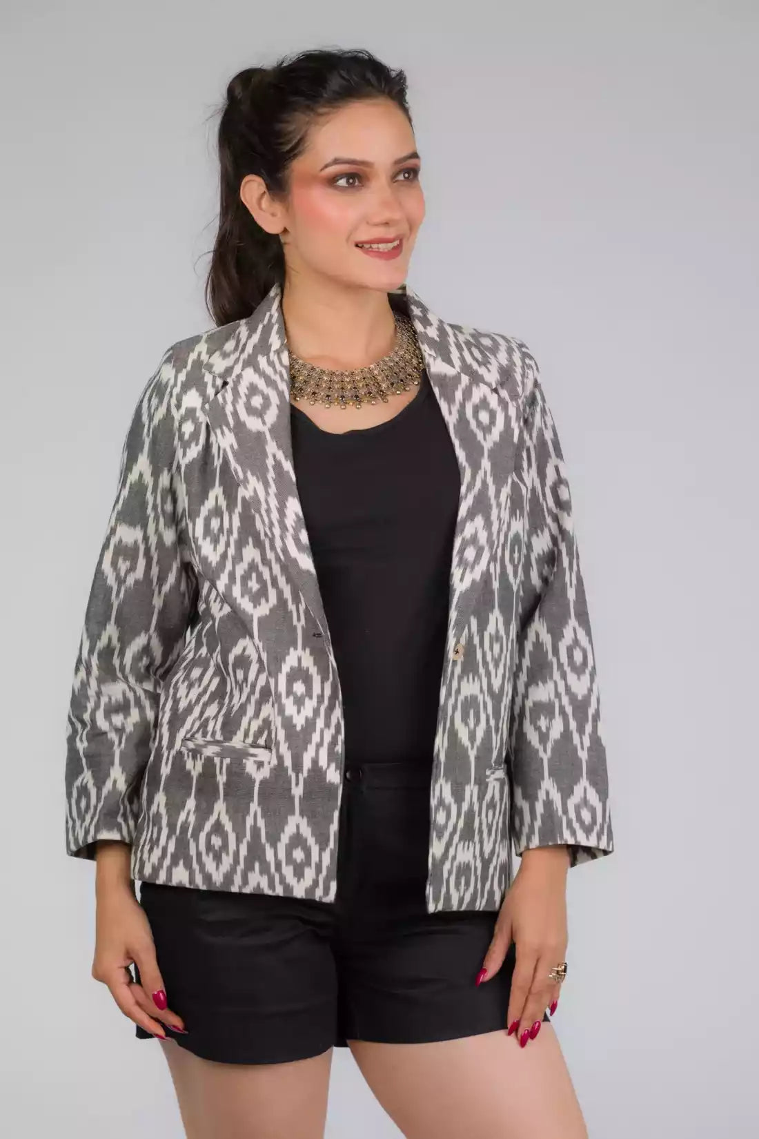 A Women in Grey Woven Ikkat Blazer In Pure Cotton, womens workwear standing against a grey background