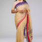 a beautiful woman with short hair wearing beige saree with collared blouse and multicolor borders at both ends of the saree