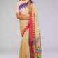 front view of a beautiful woman posing in beige saree with collared blouse and multicolor borders at both ends of the saree