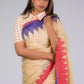 closure view of a beautiful woman posing in beige saree with collared blouse and multicolor borders at both ends of the saree