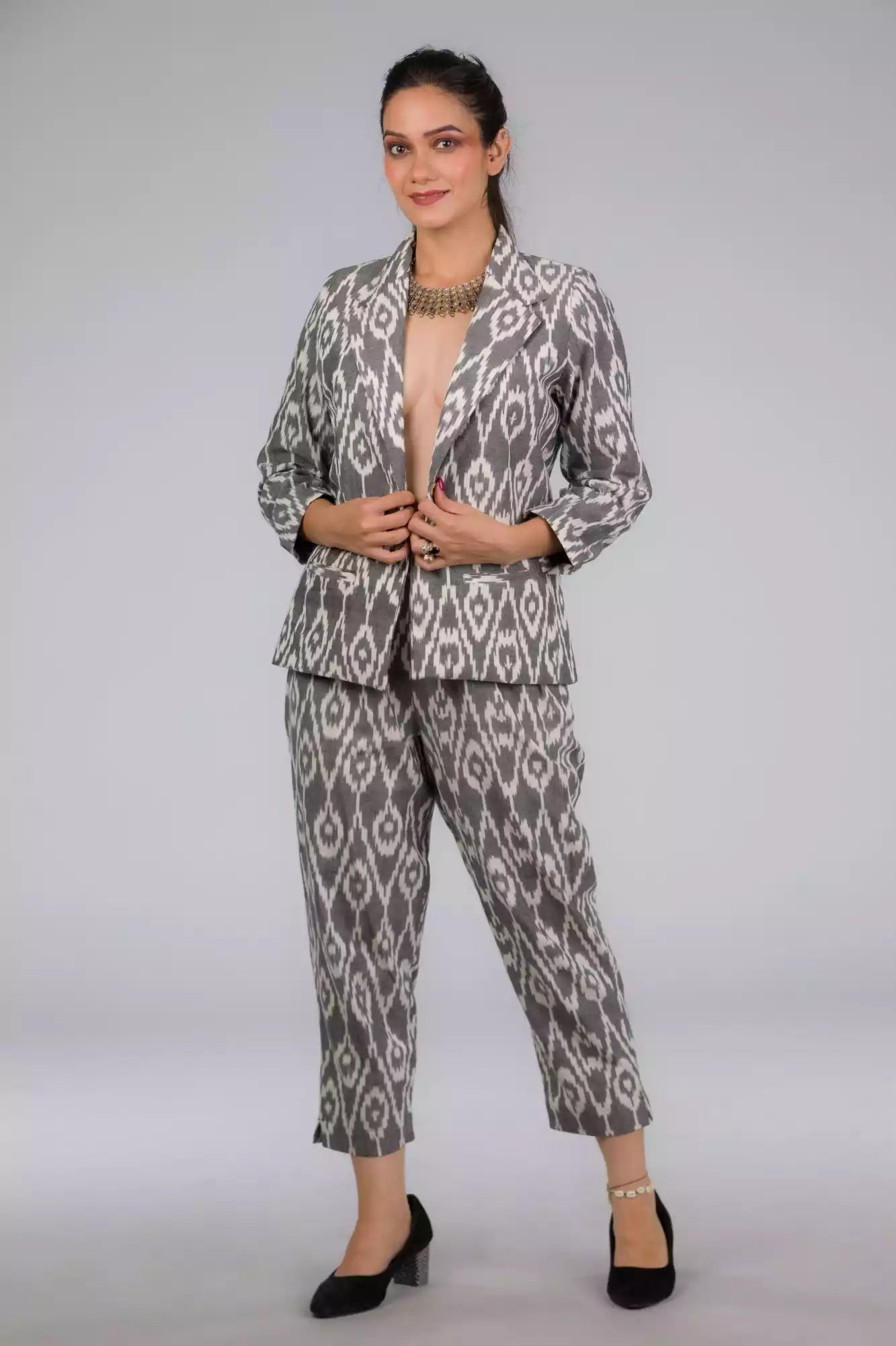 A lady in Grey Woven Ikkat bottom In Pure Cotton, womens workwear standing against a grey background