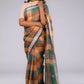 A gorgeous women in Earthy Brown & Peacock Green Checkered Linen Saree, a office wear for women looking to her left side