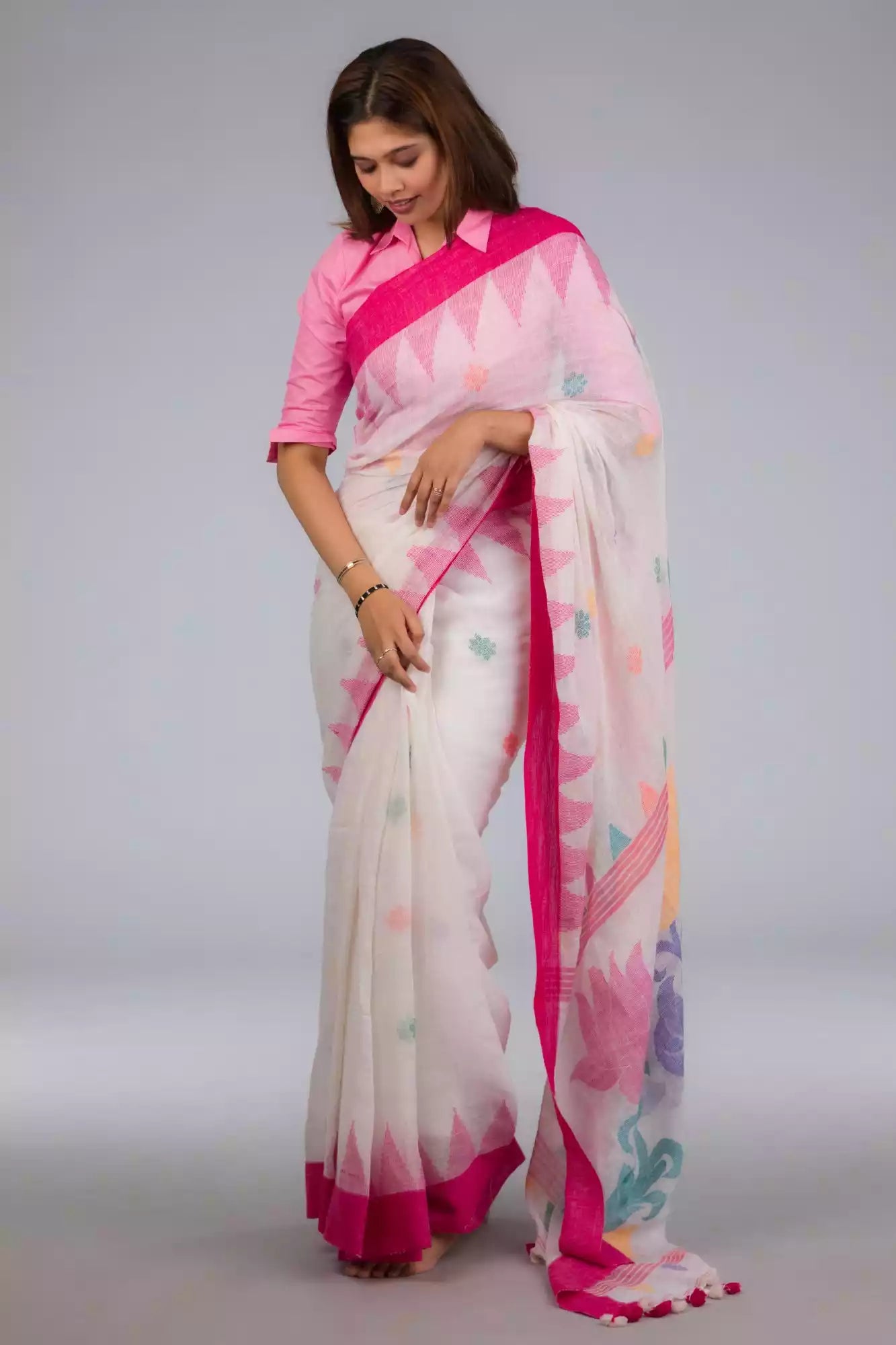 A zoomed out view of women wearing a Fuchsia Pink & Dovetail White Jamdani Work Saree, formal dress for women