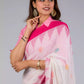 A beautiful picture of Fuchsia Pink & Dovetail White Jamdani Work Saree, womens workwear standing against a grey background looking sideways