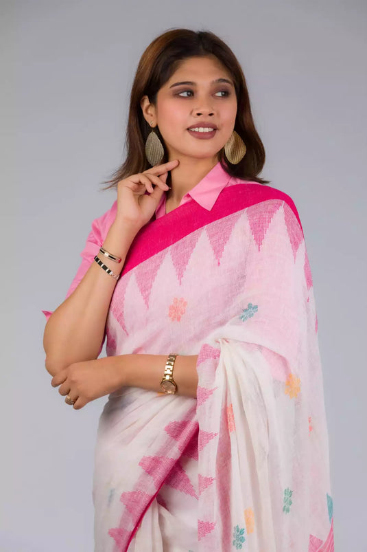 A beautiful picture of Fuchsia Pink & Dovetail White Jamdani Work Saree, womens workwear standing against a grey background looking sideways