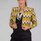A lady in Green Chevron Blazer In Pure Cotton, womens workwear standing against a grey background 