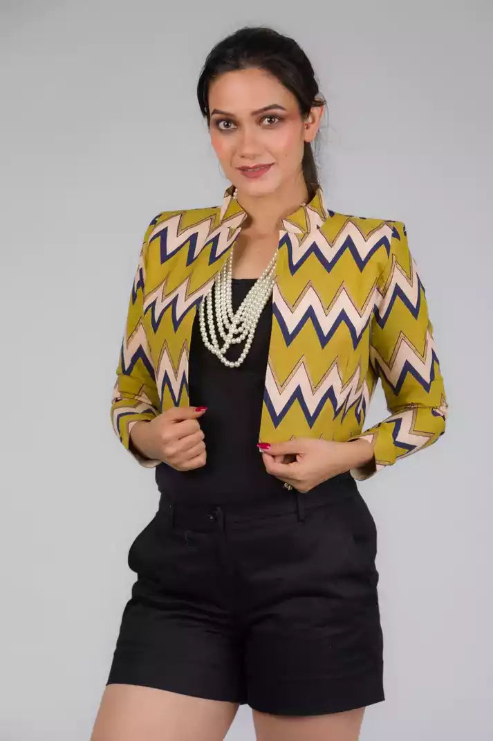 A lady in Green Chevron Blazer In Pure Cotton, womens workwear standing against a grey background 