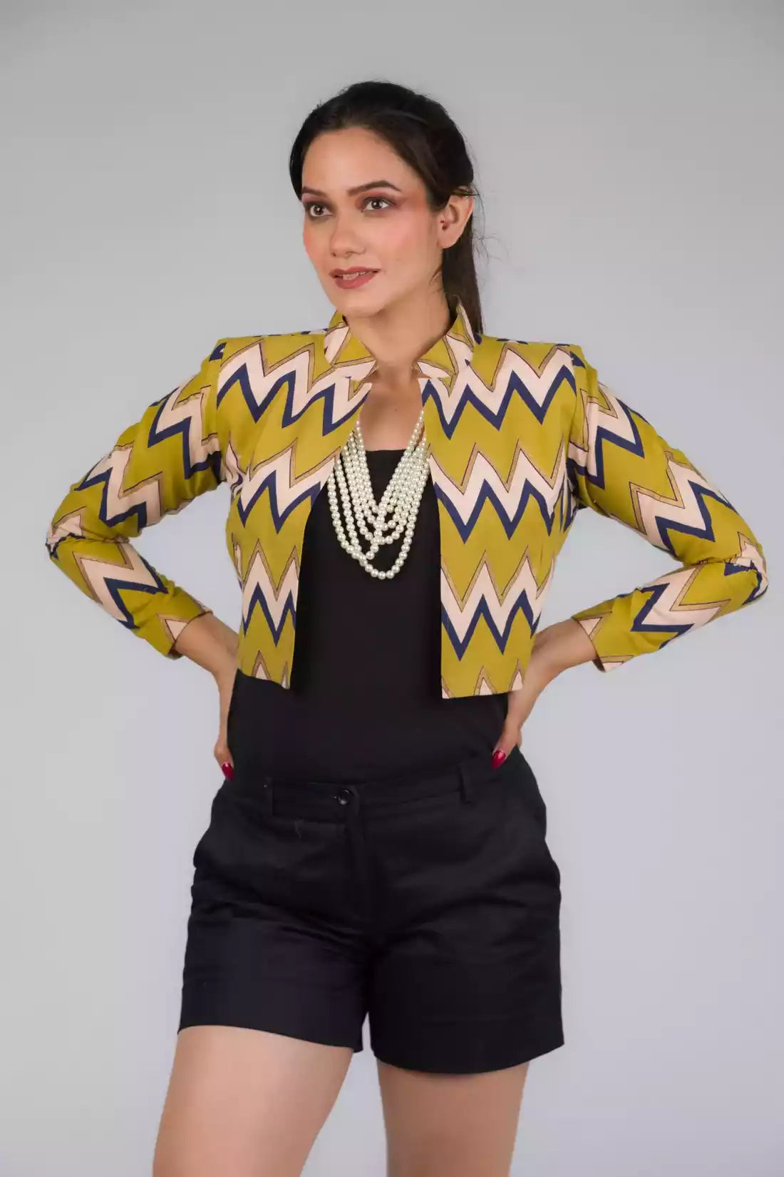A picture of Green Chevron Blazer In Pure Cotton, womens workwear standing against a grey background looking sideways