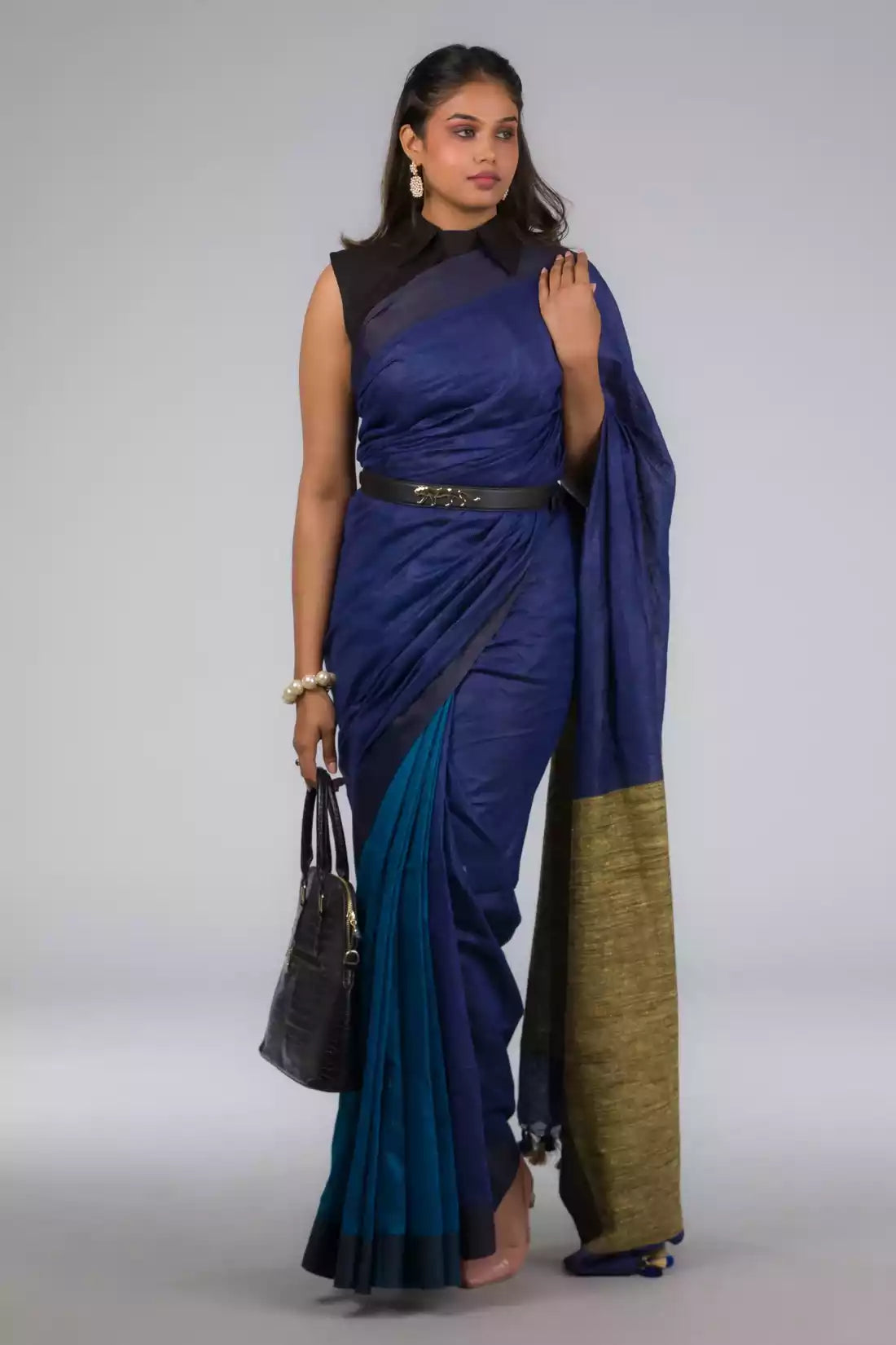 A zoomed out view of women wearing a Hues of Space Blue and Cobalt Blue Linen Woven Saree with Patli Pallu, formal dress for women