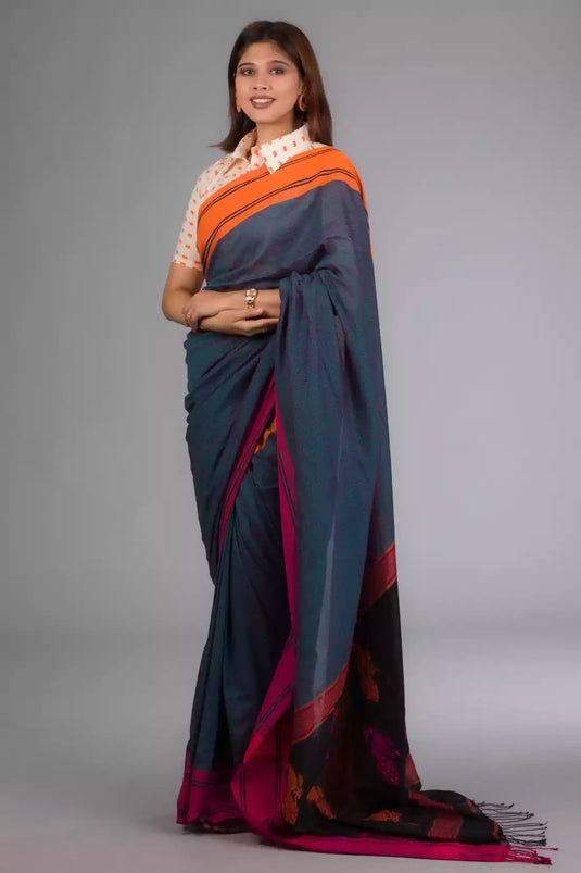 a woman in Grey - Orange &pink border with black jamdani pallu In Pure Cotton Saree, a business formal for women standing in front of a beige backdrop
