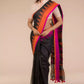 a woman in Black with Orange and pink border Jamdani hand weaving Saree, a business formal for women standing in front of a beige backdrop