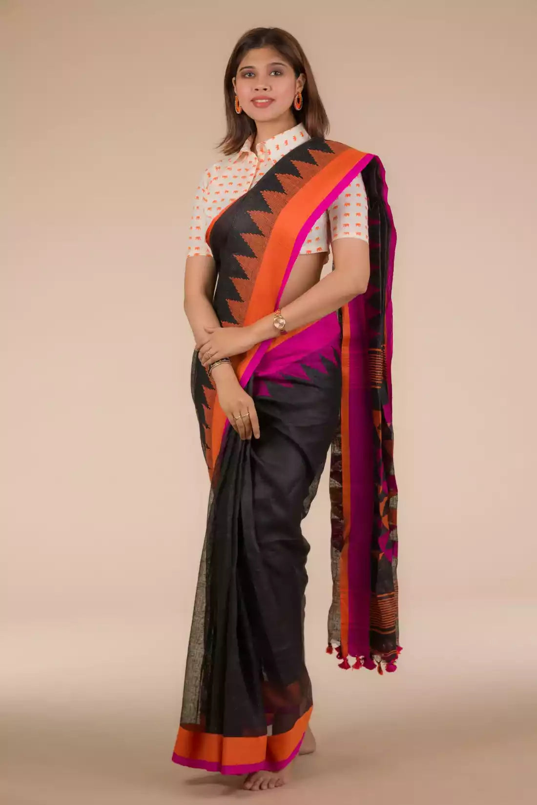 a woman looking sideways wearing formal workwear Black with Orange and pink border Jamdani hand weaving Saree In Pure Cotton Saree