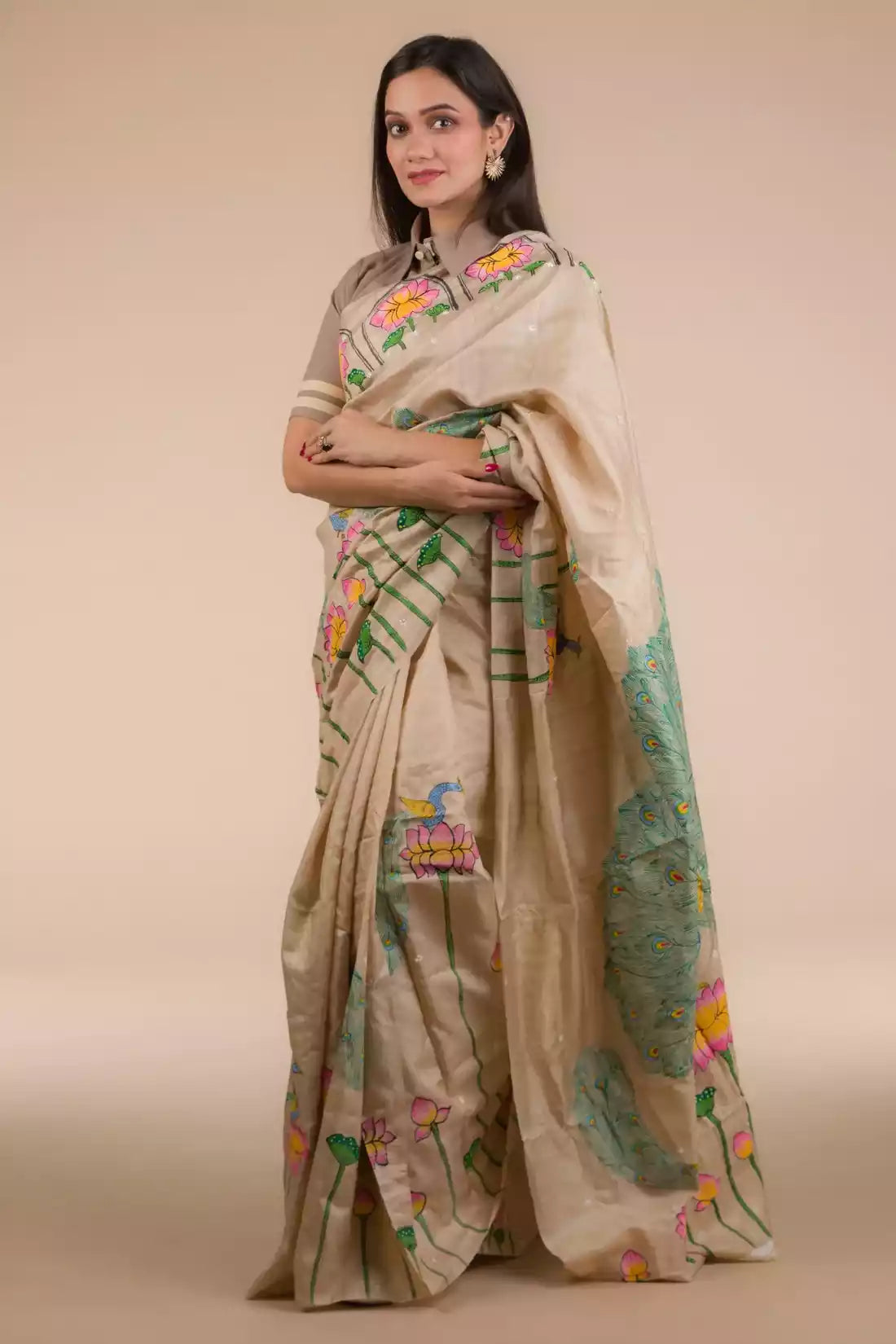 A zoomed out view of women wearing a Hand-painted Patachitra Lotus & Peacock design Pure Tussar Saree in Beige, formal dress for women