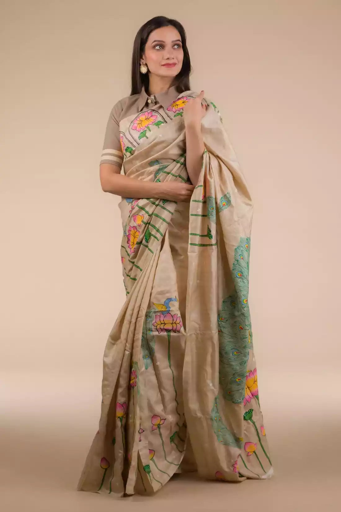 An aesthetic image of lady in Hand-painted Patachitra Lotus & Peacock design Pure Tussar Saree in Beige, womens workwear 