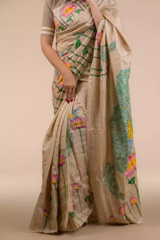 A gorgeous women in Hand-painted Patachitra Lotus & Peacock design Pure Tussar Saree in Beige, a office wear for women 