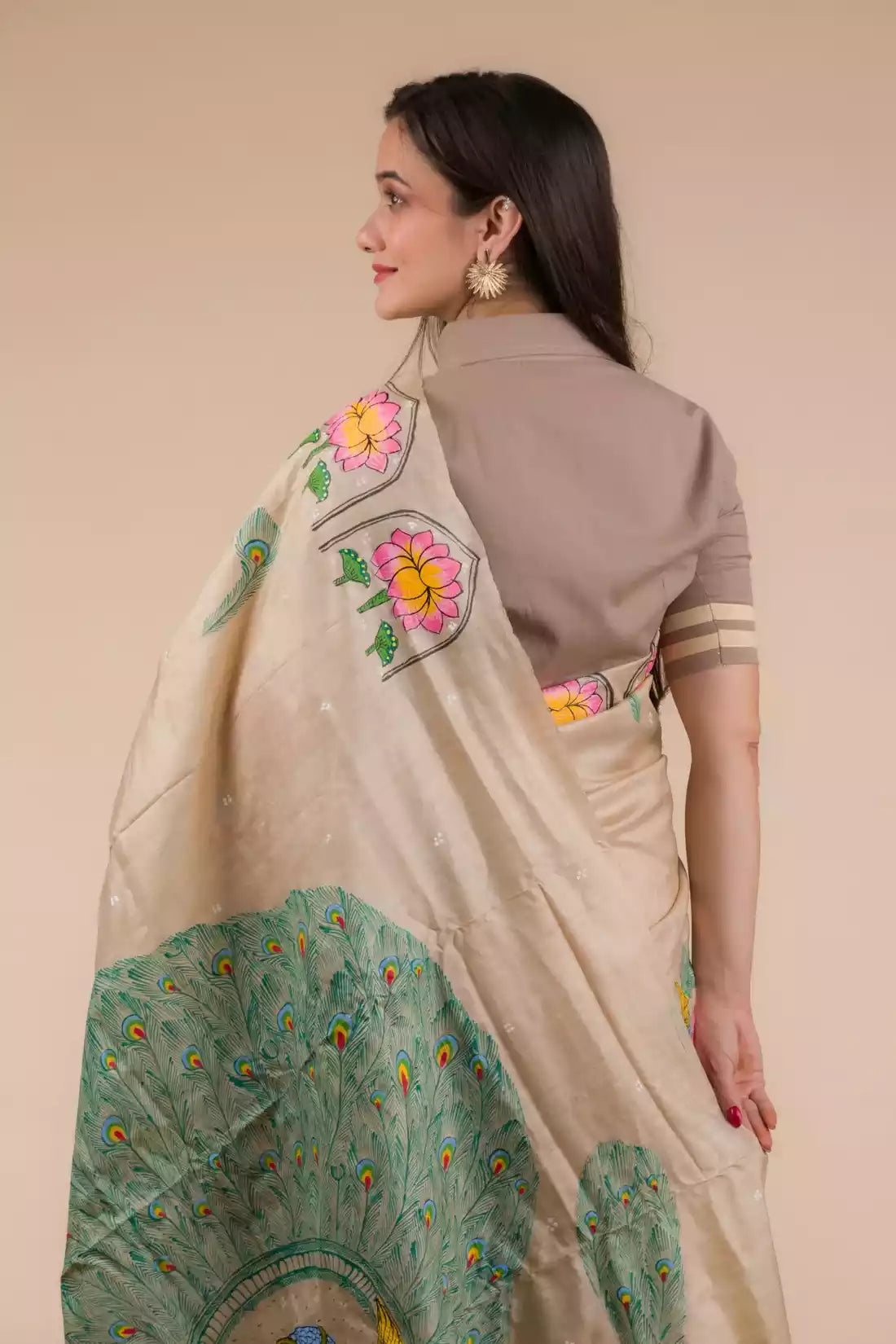 A beautiful back view of lady in Hand-painted Patachitra Lotus & Peacock design Pure Tussar Saree in Beige, womens workwear